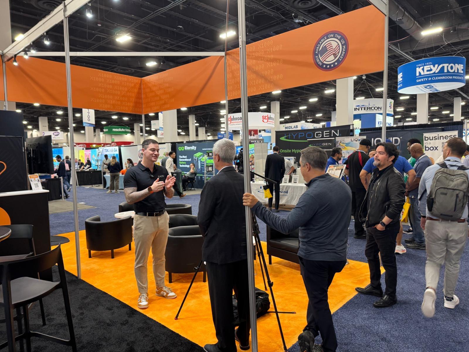 people standing and talking at tradeshow booth