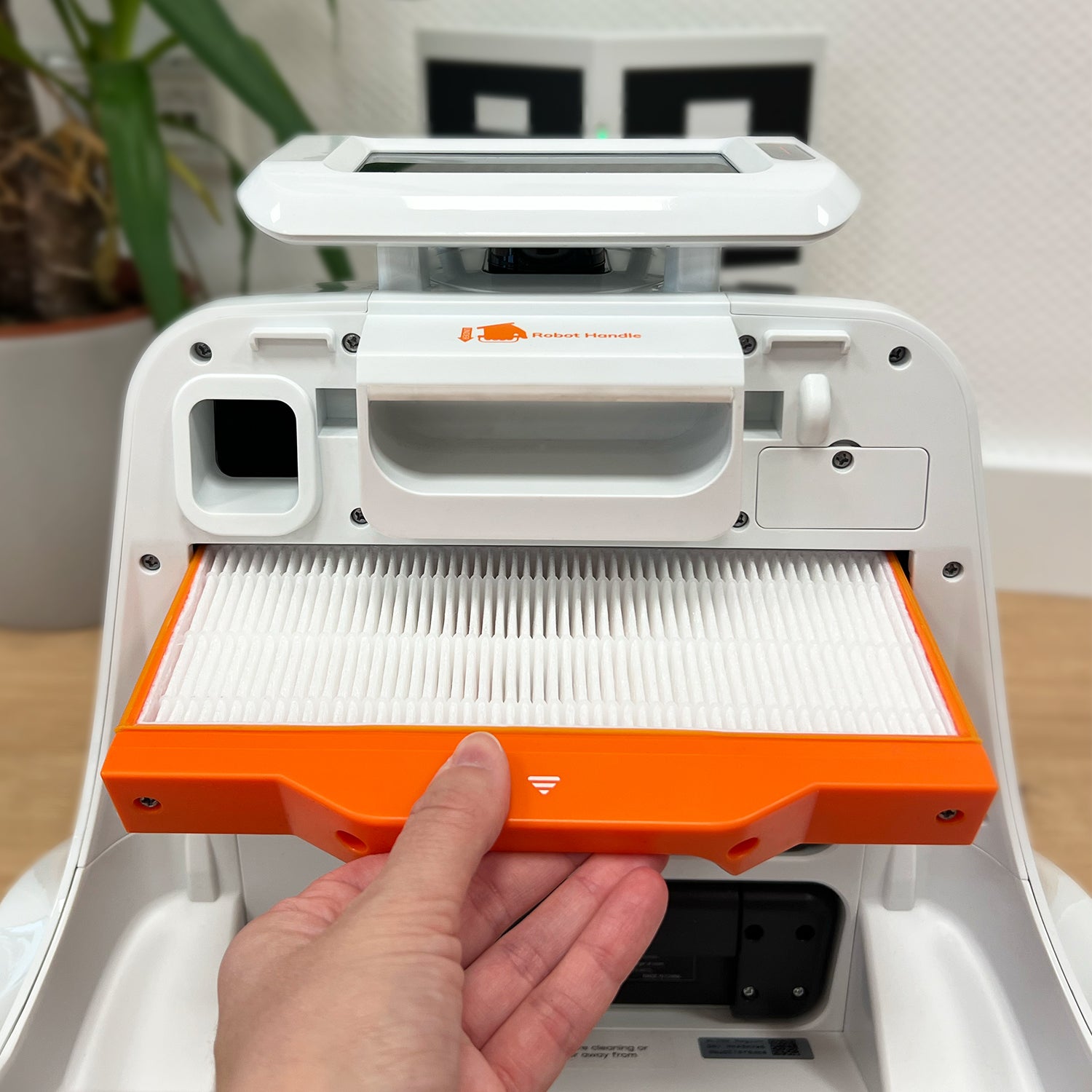 hand changing the HEPA 13 filter