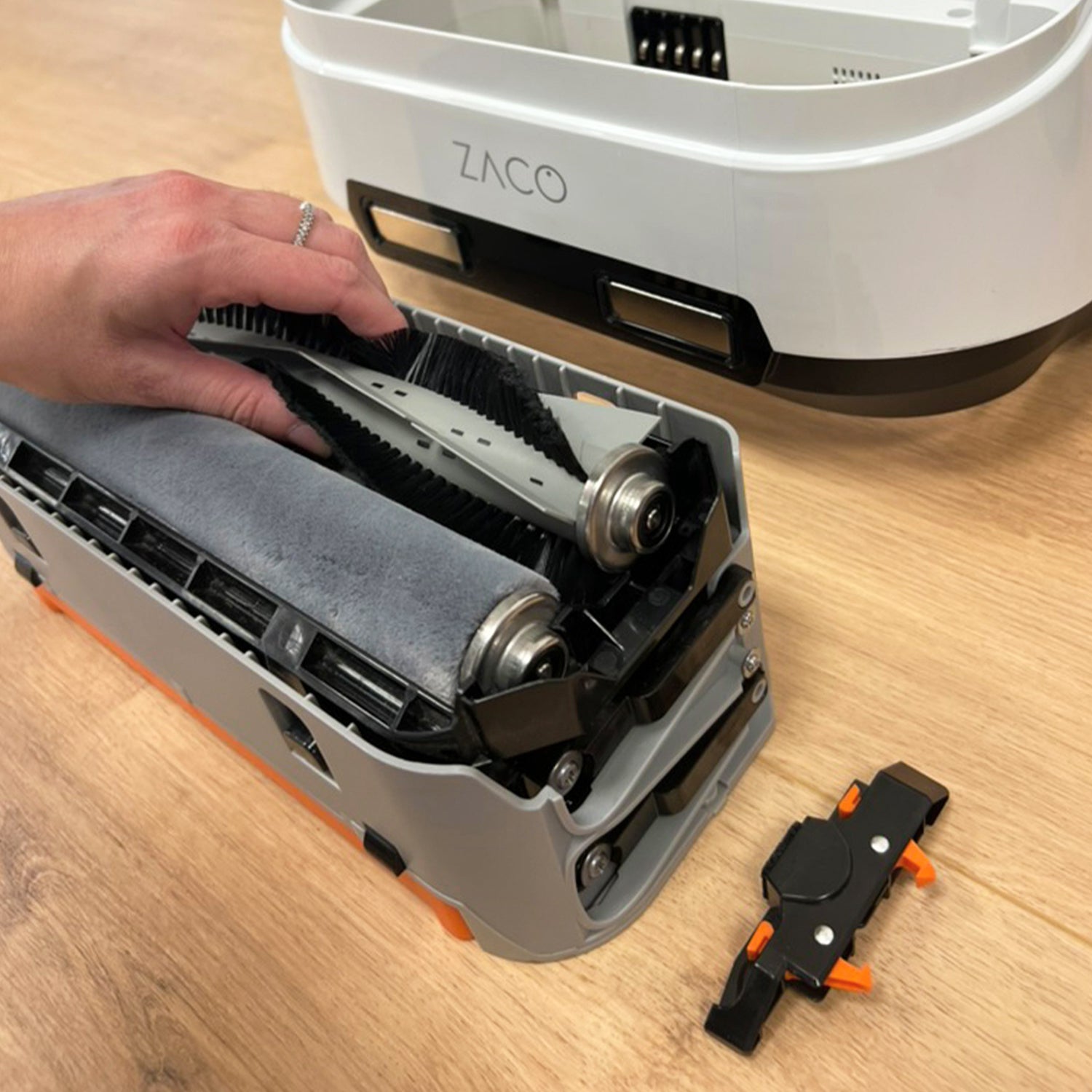 hand changing main brushes of cleaning module