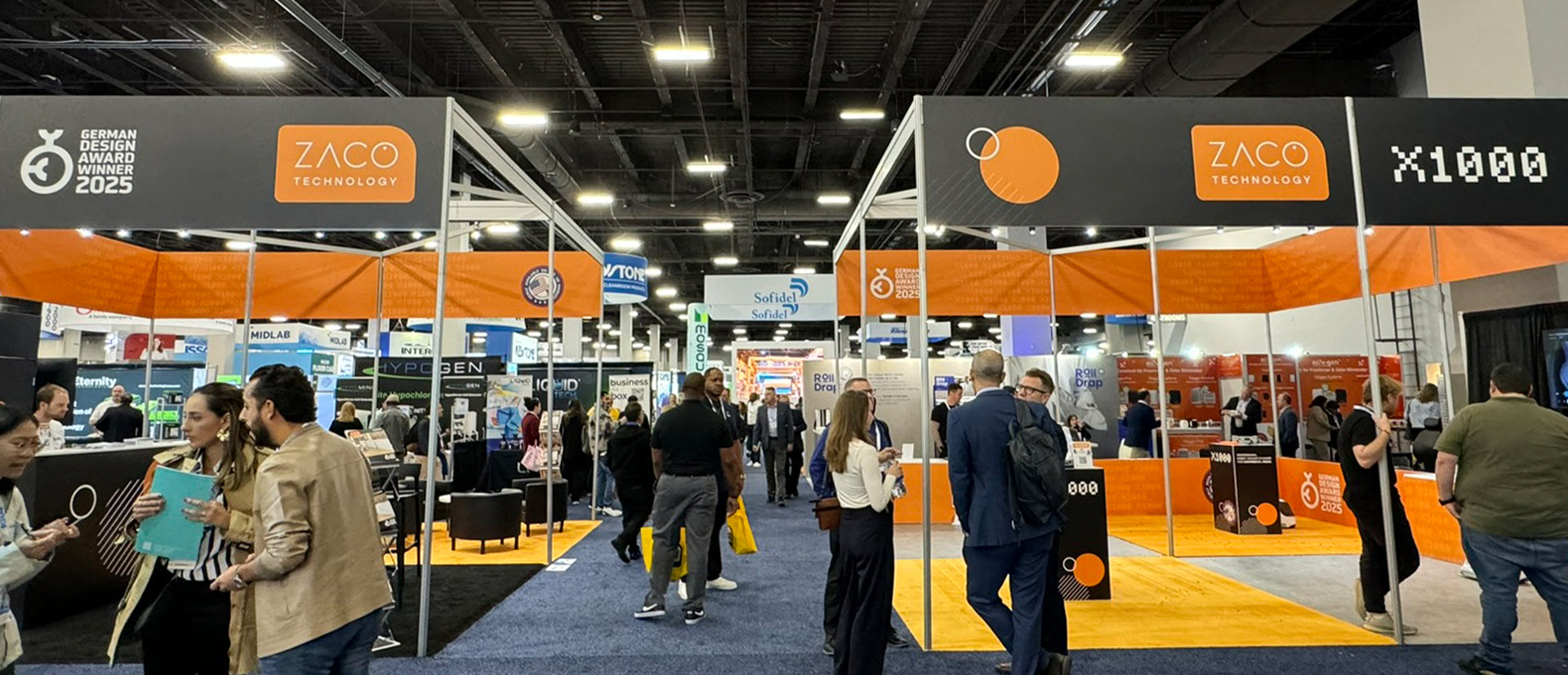 tradeshow booth of ZACO Technology with people talking